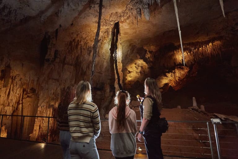 Women, child and tour guide inside Jewel Cave, Augusta.