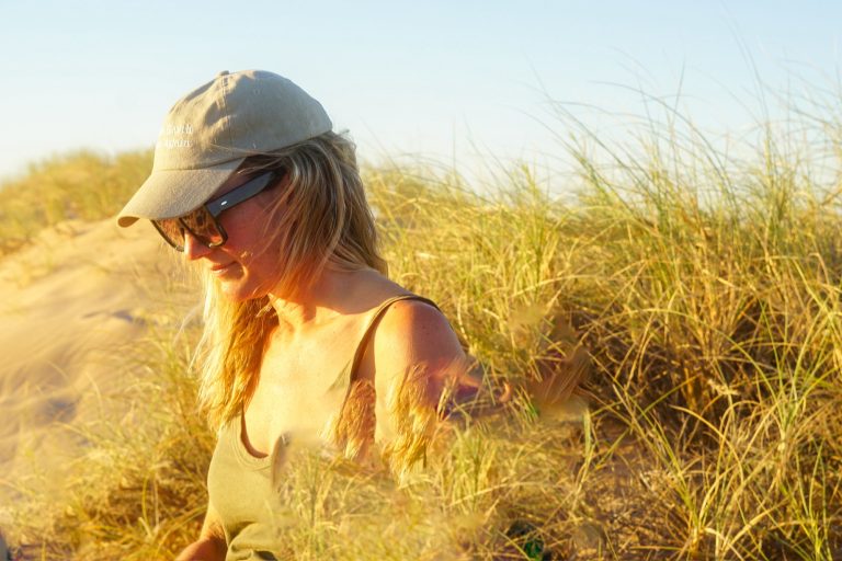 Solo artist, IKSRE (Phoebe Dubar) standing in a grassy field